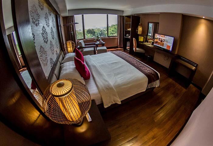 Rose Garden Hotel room: Gay-friendly hotel featuring a king-size bed, desk, TV, and a view. Ideal for gay men's travel and relaxation.