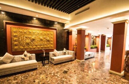 Lobby interior at Gay-Friendly Rose Garden Hotel. Sofas, artwork, and marble floor. Elegant decor in this gay hotel.