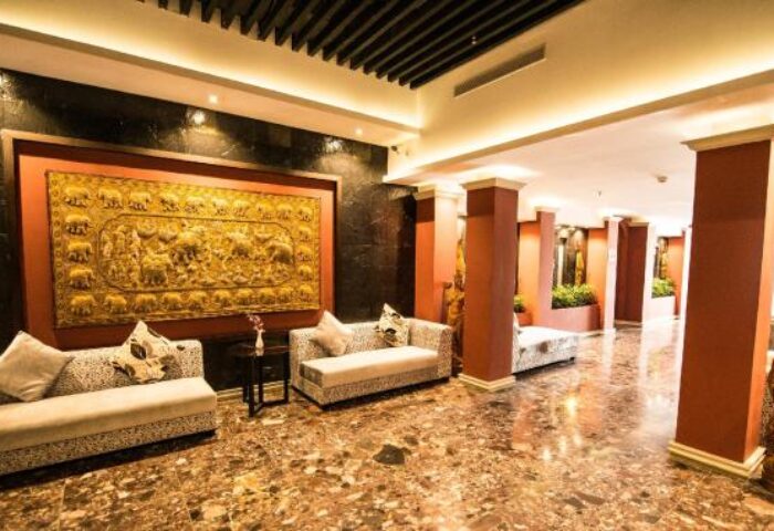Lobby interior at Gay-Friendly Rose Garden Hotel. Sofas, artwork, and marble floor. Elegant decor in this gay hotel.