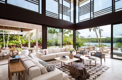 Rosewood Mayakoba gay-friendly hotel suite interior. Modern design, floor-to-ceiling windows, lagoon view, luxury travel, gay vacation.