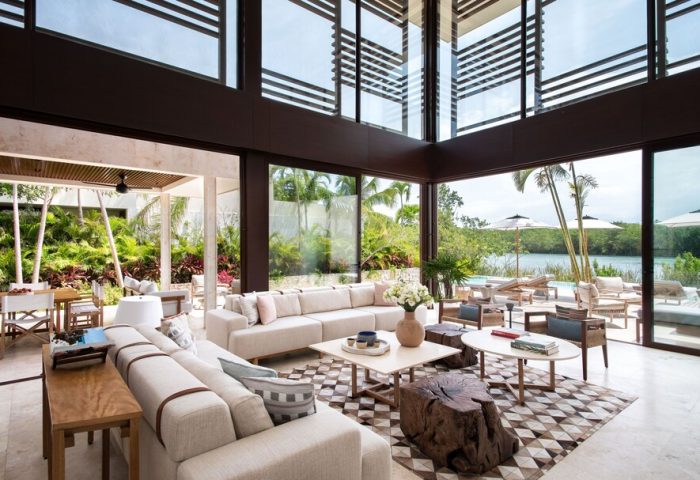 Rosewood Mayakoba gay-friendly hotel suite interior. Modern design, floor-to-ceiling windows, lagoon view, luxury travel, gay vacation.