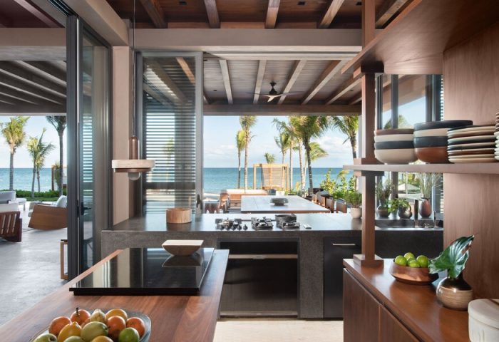 Rosewood Mayakoba gay-friendly hotel kitchen with ocean view. Luxury resort with modern design, palm trees, and outdoor dining.