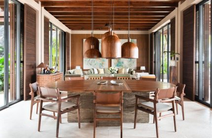 Rosewood Mayakoba gay-friendly hotel dining area. Wood table, chairs, and ceiling. Tropical decor, luxury resort. Ideal for gay travel.