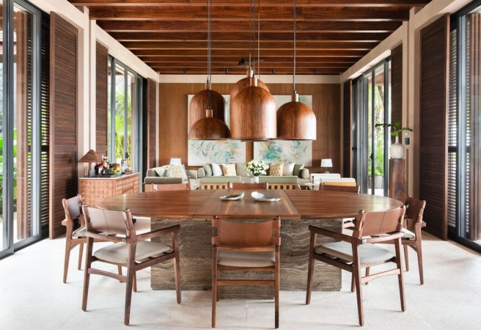 Rosewood Mayakoba gay-friendly hotel dining area. Wood table, chairs, and ceiling. Tropical decor, luxury resort. Ideal for gay travel.