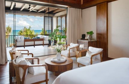 Rosewood Mayakoba gay-friendly hotel suite. Room with ocean view, balcony seating, & modern decor. Luxury travel for gay men in Riviera Maya.