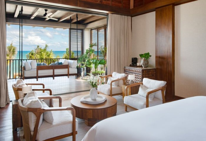 Rosewood Mayakoba gay-friendly hotel suite. Room with ocean view, balcony seating, & modern decor. Luxury travel for gay men in Riviera Maya.