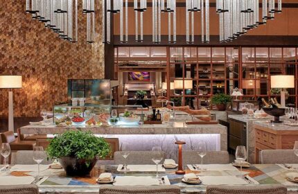 Rosewood Yangon's dining area. Gay-friendly, pet-friendly hotel features a buffet, stylish lighting, and elegant table settings.