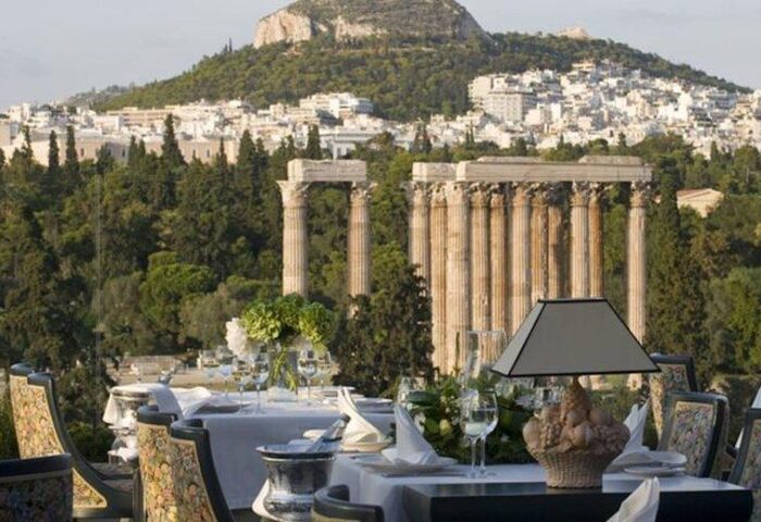 Royal Olympic Hotel gay-friendly view. Temple of Zeus and Athens cityscape seen from rooftop restaurant. Gay travel advice for Athens.