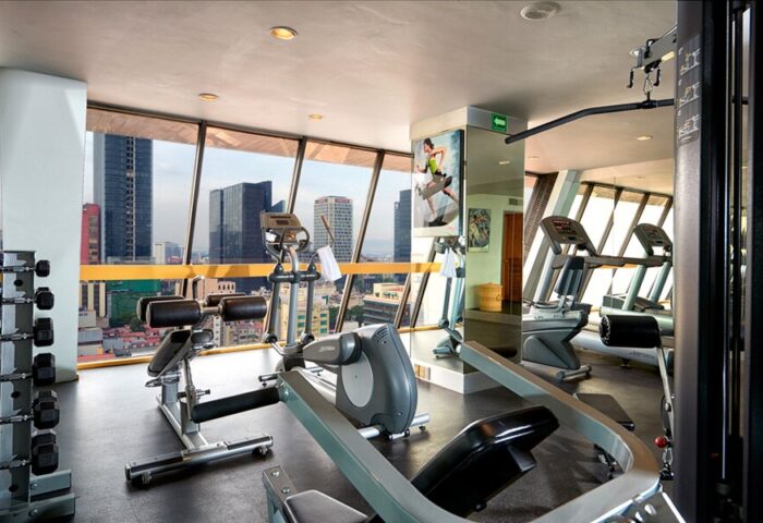 Hotel Royal Reforma's gym, a gay-friendly Zona fitness center. Exercise equipment and city views. Ideal for gay men's travel in Mexico City.
