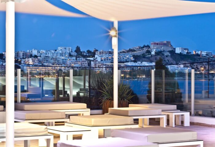 Ryans Ibiza Apartments adults-only rooftop lounge at night. Gay-friendly hotel with stunning city views. Perfect for gay travel in Ibiza.