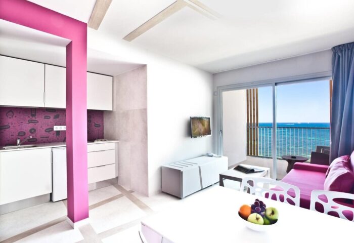 Ryans Ibiza Apartments interior. Adults-only, gay-friendly hotel room with sea view, kitchen, and modern design. Perfect for Ibiza holidays.