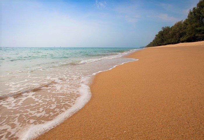 SALA Phuket Mai Khao Beach Resort: Waves gently washing onto the sandy shore. Gay-friendly hotel in Phuket offers a serene beach experience.