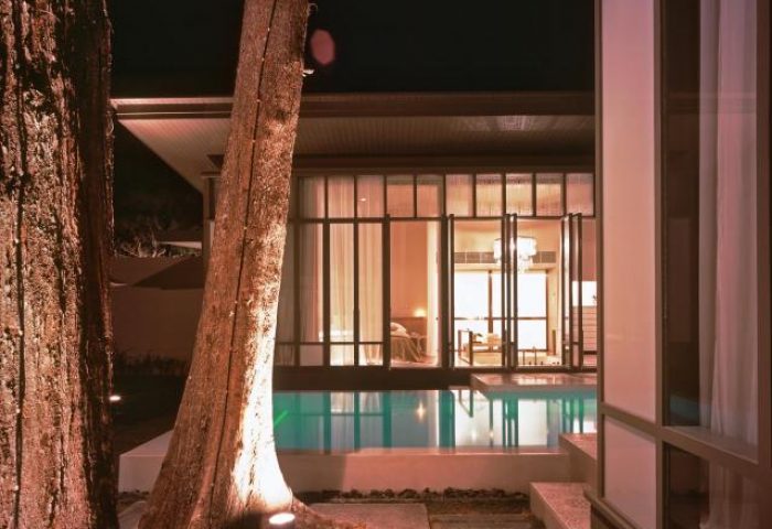 SALA Phuket Mai Khao Beach Resort pool view at night. Gay-friendly hotel with luxury accommodations for gay travelers in Phuket.