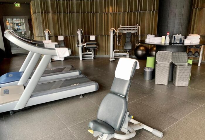 SANA Berlin Hotel gym with treadmills, weight machines, and fitness equipment. This gay-friendly hotel is also pet-friendly.