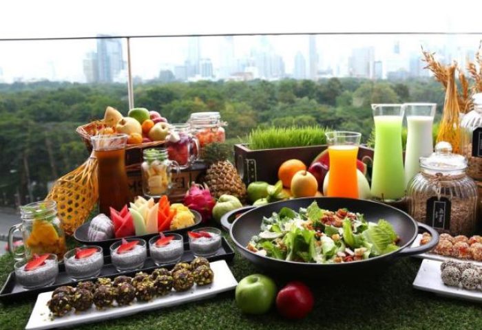 SO/ Bangkok gay-friendly hotel breakfast buffet. Fresh fruits, salad, juices, and healthy options with a city view. Gay travel in Thailand.