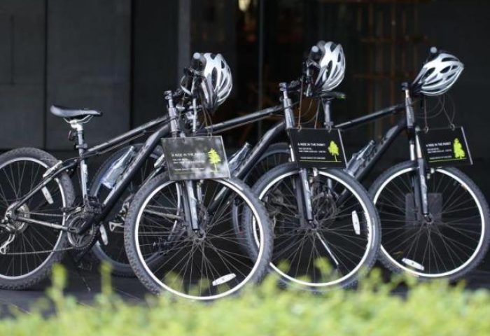Bikes at SO/ Bangkok, a gay-friendly hotel. Helmets hang on handlebars. Explore Bangkok, Thailand on two wheels. Cycling adventure.