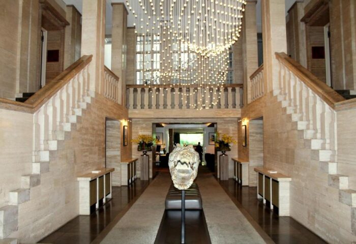 SO/ Berlin Das Stue's grand lobby. Pet-friendly, gay-friendly hotel with striking design. Alligator skull sculpture, stairs, & chandelier.