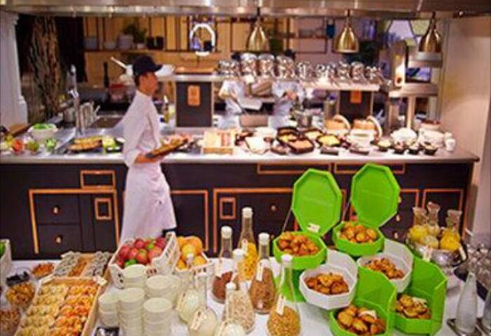 SO/ Sofitel Singapore's buffet. Gay-friendly hotel with a chef serving food. Fresh fruit, pastries, and other breakfast items.