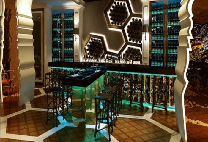 SO/ Sofitel Singapore gay-friendly hotel bar. Modern design with hexagon shelves holding wine bottles. A great place for gay men to socialize.
