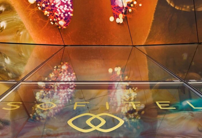 SO/ Vienna gay-friendly hotel detail. Abstract ceiling art and Sofitel logo at this stylish Vienna hotel. Gay travel advice.