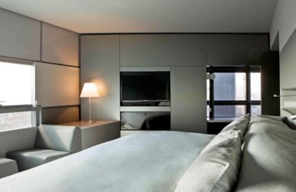 SO/ Vienna gay-friendly hotel room. Modern design with a large bed, TV, and seating area by the window. Ideal for gay travel in Vienna.