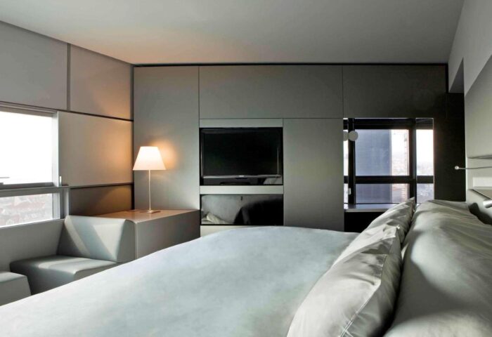 SO/ Vienna gay-friendly hotel room. Modern design with a large bed, TV, and seating area by the window. Ideal for gay travel in Vienna.