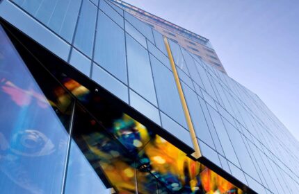SO/ Vienna, a gay-friendly hotel. Modern glass building with colorful art installation. A great stay for gay travelers in Vienna, Austria.