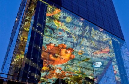 SO/ Vienna gay-friendly hotel. Exterior view of the modern glass building with colorful art installation. Vienna travel advice for gay men.