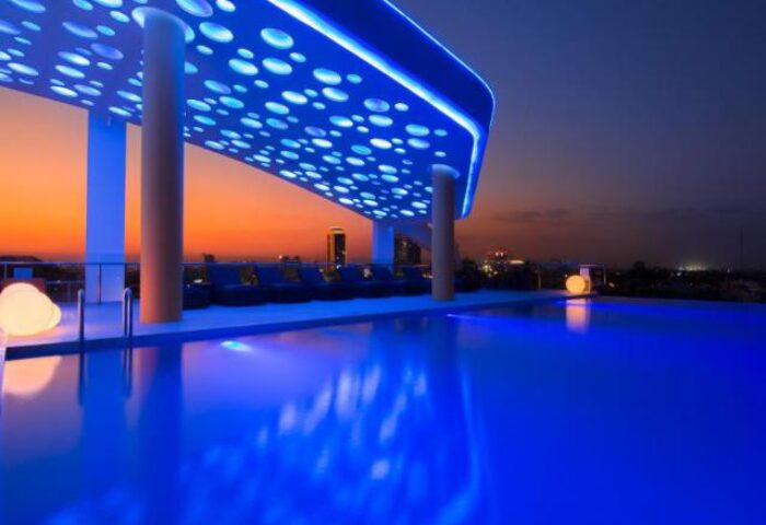 SUN & MOON Urban Hotel's rooftop pool at dusk. This gay-friendly hotel features a stylish design and city views, perfect for gay travelers.