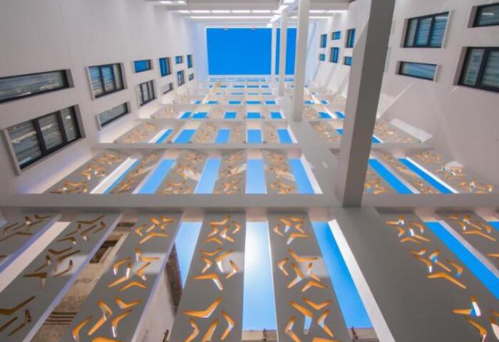 Architectural detail at SUN & MOON Urban Hotel, a gay-friendly hotel. View looking up at the sky through decorative openings.