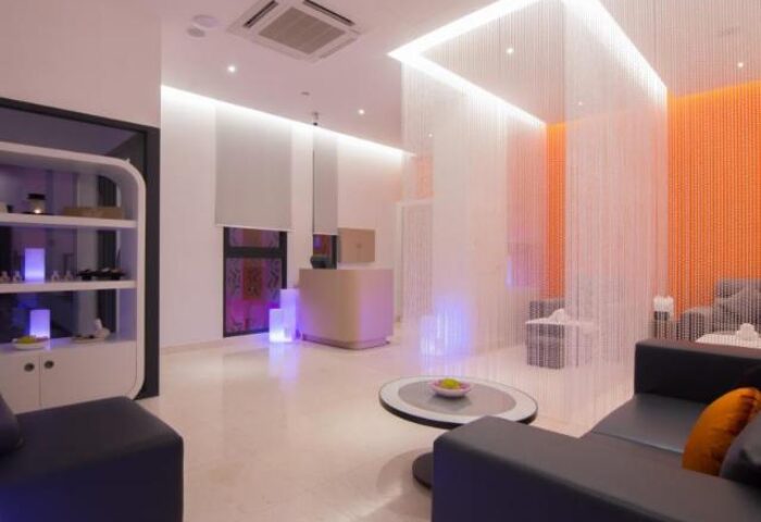 SUN & MOON Urban Hotel lobby. Gay-friendly hotel interior with modern design, seating area, and reception. Urban travel for gay men.