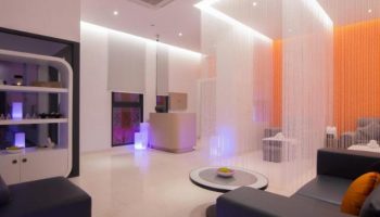 SUN & MOON Urban Hotel lobby. Gay-friendly hotel interior with modern design, seating area, and reception. Urban travel for gay men.