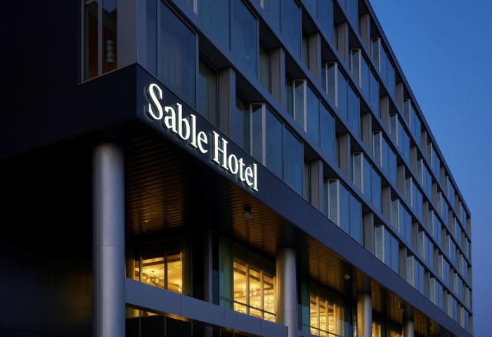 Sable at Navy Pier Chicago, a gay-friendly Curio Collection by Hilton hotel. Exterior view of the Sable Hotel at dusk.