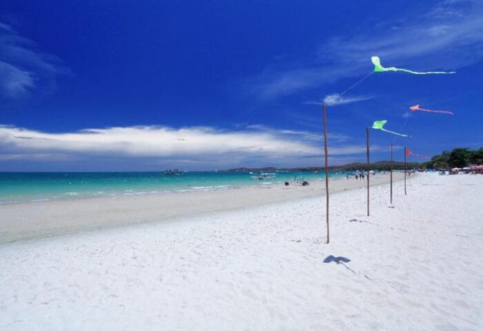 Sai Kaew Beach Resort: White sand beach, turquoise sea, and blue sky. Kites flying. Gay-friendly hotel for an idyllic vacation.