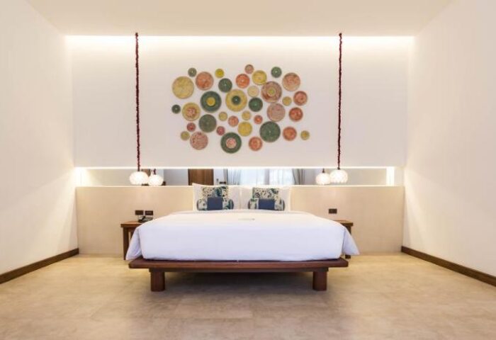 Samed Club Resort gay-friendly hotel room. Modern decor, king bed, unique wall art, and pendant lights. Ideal for gay men travel.