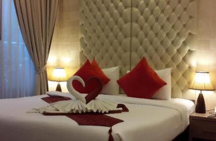 Gay-Friendly Hotel Samed Pavilion Resort: Bed with swan towels and heart. Red pillows. Luxury headboard. Romantic setting. Gay travel.