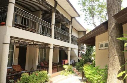 Samed Villa Resort exterior. Gay-friendly hotel with balconies, tropical plants, and walkways. A welcoming space for gay travelers.