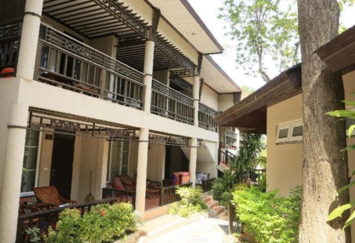 Samed Villa Resort exterior. Gay-friendly hotel with balconies, tropical plants, and walkways. A welcoming space for gay travelers.