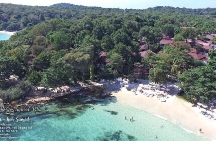 Aerial view of Samed Villa Resort, a gay-friendly hotel on Koh Samed. Lush greenery meets the turquoise sea and sandy beach, perfect for gay travelers.