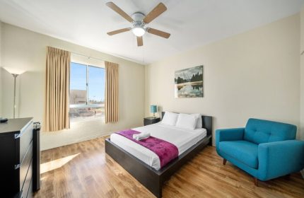 Samesun Hollywood (formerly Walk of Fame Hostel) gay-friendly hotel room. Features a bed, chair, ceiling fan and a view. Great for gay travel.