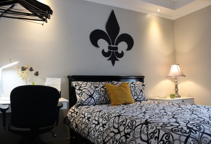 Samesun Montreal Central gay-friendly hotel room. Bed with fleur-de-lis decor, desk, and lamp. Ideal for gay men travelers.