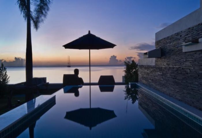 Samui Resotel Beach Resort pool view at dusk. Gay-friendly hotel in Samui, Thailand, offers luxury accommodations with stunning ocean views.