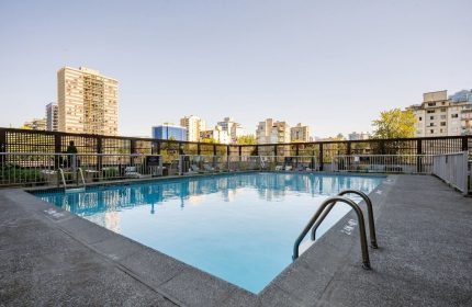 Pool at Sandman Suites Vancouver Davie Street, a gay-friendly hotel. View of the city skyline from the pool area. Relax and enjoy your stay.