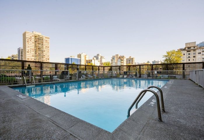 Pool at Sandman Suites Vancouver Davie Street, a gay-friendly hotel. View of the city skyline from the pool area. Relax and enjoy your stay.