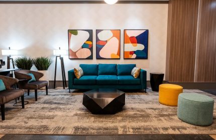 Sandman Suites Vancouver Davie Street lobby. Gay-friendly hotel with modern decor, colorful art, & comfortable seating. Great for gay travel.