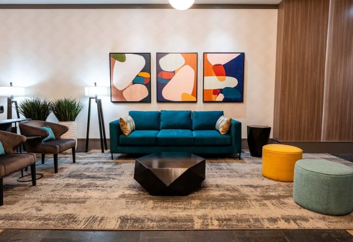 Sandman Suites Vancouver Davie Street lobby. Gay-friendly hotel with modern decor, colorful art, & comfortable seating. Great for gay travel.
