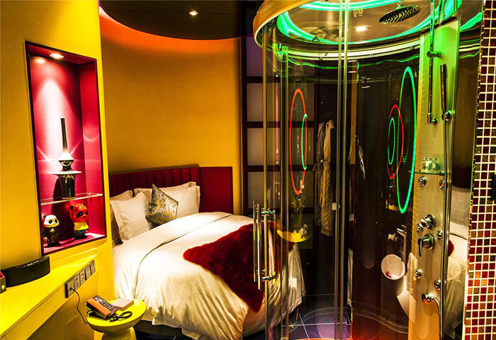 Sanlitun Mark Jacobs Boutique Hotel room. Gay-friendly hotel with a bed, shower with neon lights, and colorful decor. Modern design.