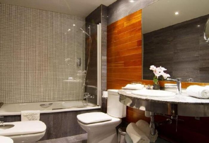 Sansi Diputacio Hotel bathroom. Modern design with tub, shower, toilet, bidet, and sink. Gay-friendly hotel in Barcelona, Spain.