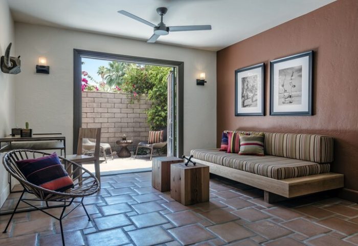 Room at Santiago Resort, Palm Springs premier gay men's resort. Interior with patio view, seating, and modern design. Gay-friendly hotel room.