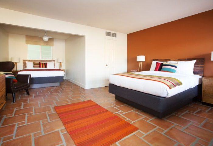 Santiago Resort, Palm Springs Gay Men's Resort: Two queen beds in a room with terra cotta tile floors and colorful accents. Gay-Friendly Hotel room.